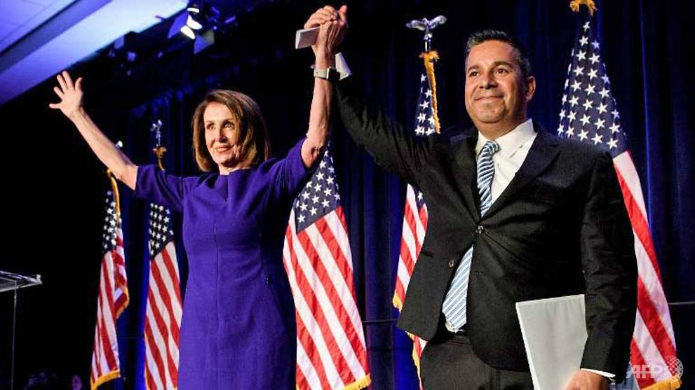 house minority leader nancy pelosi d ca and representative ben ray lujan d mn dccc chairman celebrate a projected democratic party takeover of the house of representatives during a midterm election night party photo afp