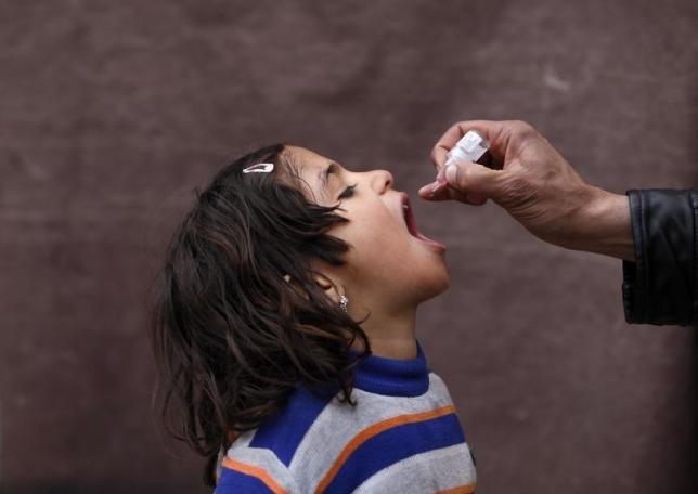 A child receives polio vaccination drops. PHOTO: REUTERS