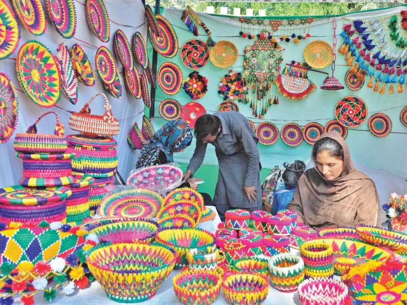 a woman displays handmade items at lok virsa photo waseem nazir express