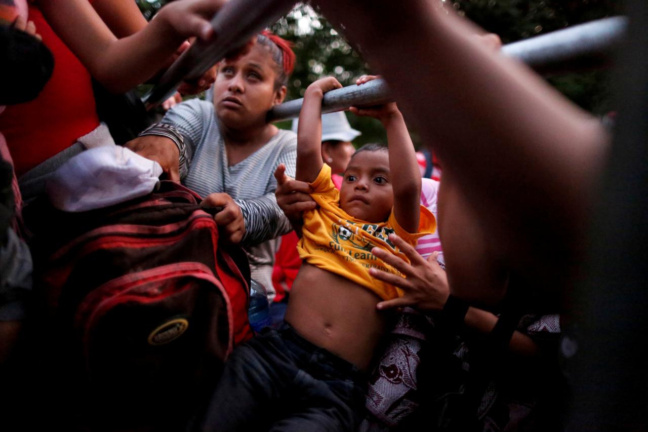 people belonging to a caravan of migrants from el salvador en route to the united states board a pick up truck for a hitchhike along the highway to ciudad tecun uman guatemala from moyuta guatemala photo reuters