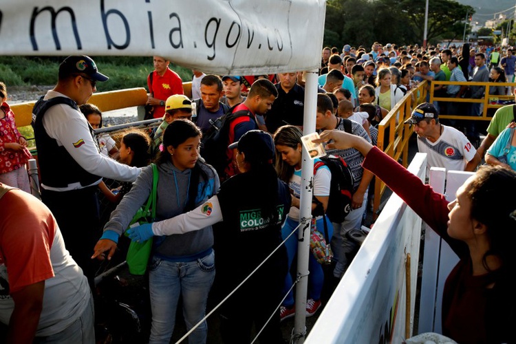 colombian migration officers check the identity documents of people trying to enter colombia from venezuela at the simon bolivar international bridge in villa del rosario colombia photo reuters