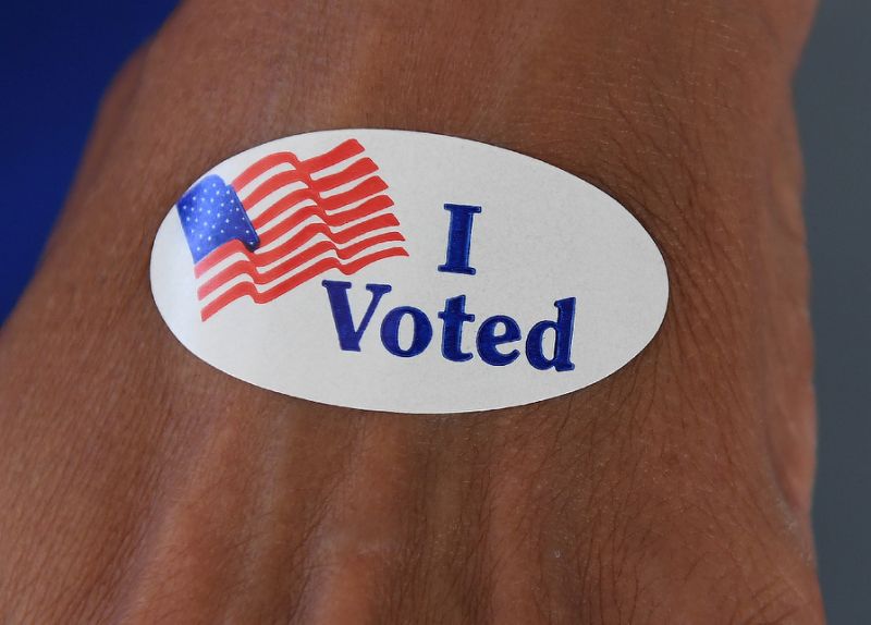 a woman shows an 039 i voted 039 sticker during the us midterm elections in which voters also cast ballots on a range of local initiatives from legalizing recreational marijuana to banning greyhound racing photo afp