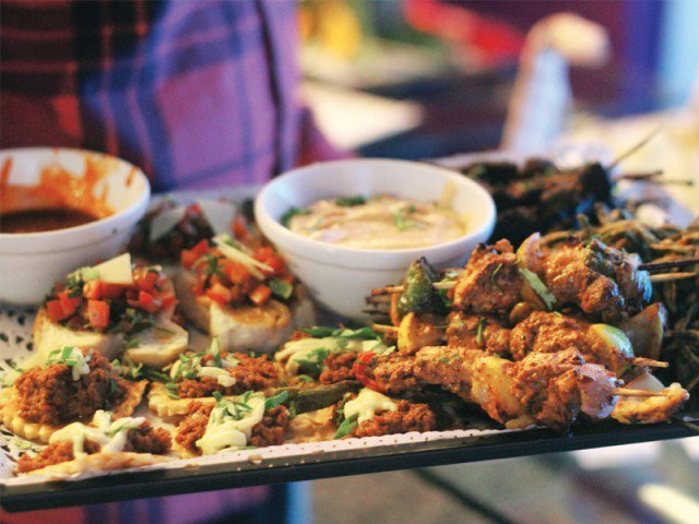 the sindh food authority has sealed both restaurants and taking samples of the food for testing photo express file