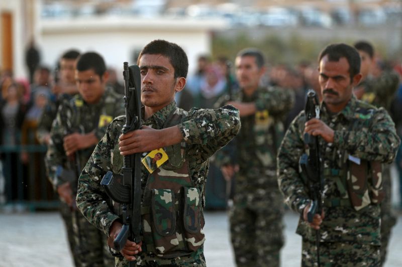 syrian democratic forces sdf fighters attend the november 6 2018 funeral of a fellow fighter killed in an offensive by the islamic state group against an sdf position in eastern syria photo afp