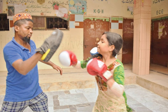 a young girl throws punches at a boxing club in lyari in recent years avenues for extracurricular activities have seen an upsurge in the neighbourhood photo courtesy zuleikha dawood a young girl throws punches at a boxing club in lyari in recent years avenues for extracurricular activities have seen an upsurge in the neighbourhood photo courtesy zuleikha dawood