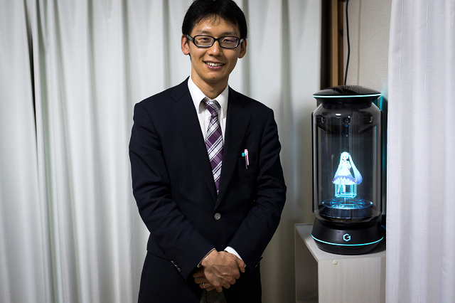 in this photograph taken on november 10 2018 japanese akihiko kondo poses next to a hologram of japanese virtual reality singer hatsune miku at his apartment in tokyo a week after marrying her photo afp in this photograph taken on november 10 2018 japanese akihiko kondo poses next to a hologram of japanese virtual reality singer hatsune miku at his apartment in tokyo a week after marrying her photo afp