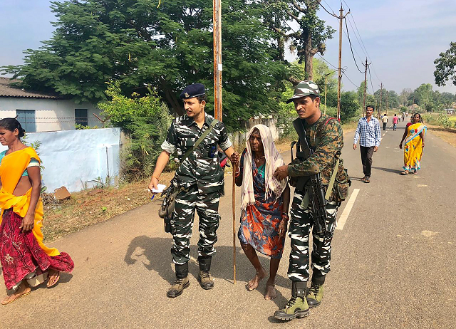 authorities assist as indian voters line up to vote at a polling station in sukma in chhattisgarh state on november 12 2018 photo afp