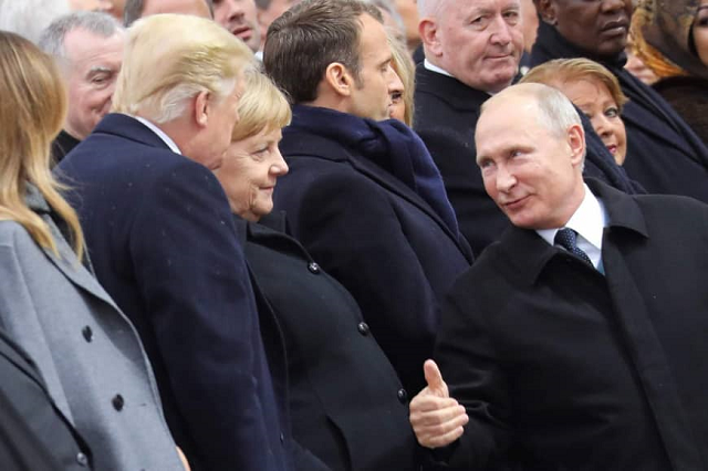 russian president vladimir putin right talks with german chancellor angela merkel center and u s president donald trump as they attend a ceremony at the arc de triomphe in paris on sunday as part of commemorations marking the 100th anniversary of the end of world war i photo afp