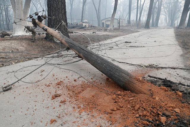 damaged power pole following the deadly camp fire blocks a path in paradise california us november 13 2018 photo reuters damaged power pole following the deadly camp fire blocks a path in paradise california us november 13 2018 photo reuters