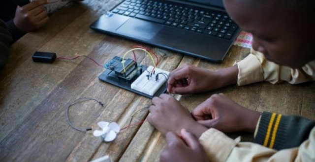 pupils at the coding club in ivory park take wires from the breadboard    the base for building an electronics circuit    to a fan that they will programmme to work from a laptop photo afp