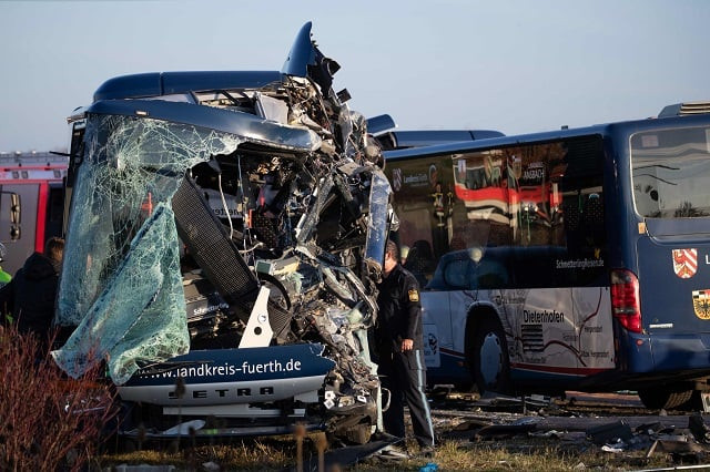 members of the emergency services work at the scene near ammerndorf southern germany where two school buses collided head on leaving around 40 children and adults injured five of them seriously police said photo afp members of the emergency services work at the scene near ammerndorf southern germany where two school buses collided head on leaving around 40 children and adults injured five of them seriously police said photo afp