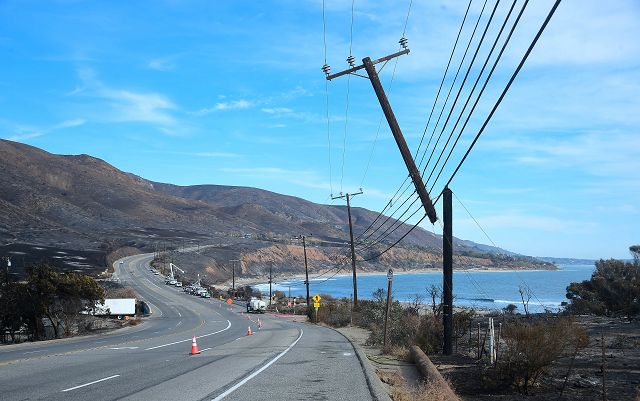 power lines are repaired along the pacific coast highway amid the blackened and charred hills from the woolsey fire in malibu california on november 15 2018 photo afp power lines are repaired along the pacific coast highway amid the blackened and charred hills from the woolsey fire in malibu california on november 15 2018 photo afp