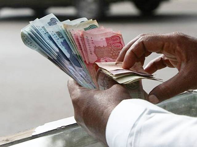 a man counts pakistani rupee pkr notes photo reuters