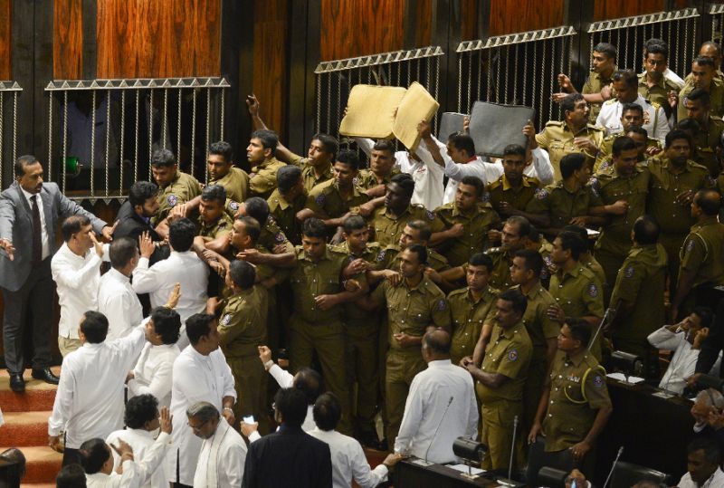 brawling erupted in parliament with rajapakse loyalists smashing furniture throwing chilli powder and projectiles at rivals in a bid to disrupt a no confidence motion against the disputed prime minister photo afp
