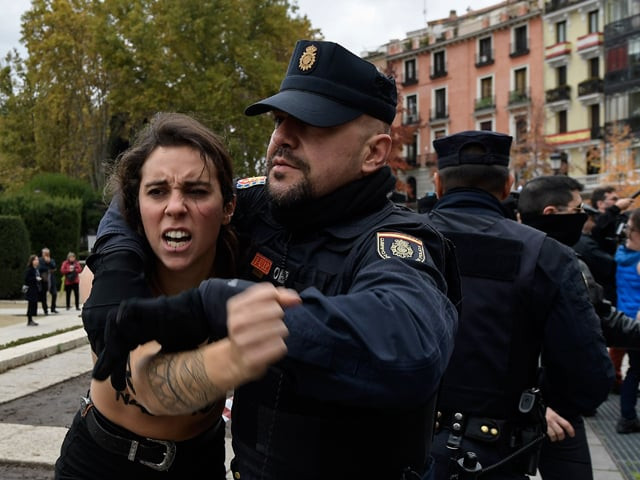 police officers subdue a member of feminist movement femen as she protests against a far right demonstration marking the anniversary of the death of spanish dictator francisco franco in madrid on november 18 2018 photo afp police officers subdue a member of feminist movement femen as she protests against a far right demonstration marking the anniversary of the death of spanish dictator francisco franco in madrid on november 18 2018 photo afp