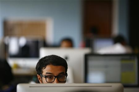 an employee works on his computer at a office photo reuters