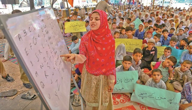 the children of dock worker study in a makeshift classroom outside the karachi press club as the protest against unpaid salaries enters its 55th day photo inp the children of dock worker study in a makeshift classroom outside the karachi press club as the protest against unpaid salaries enters its 55th day photo inp