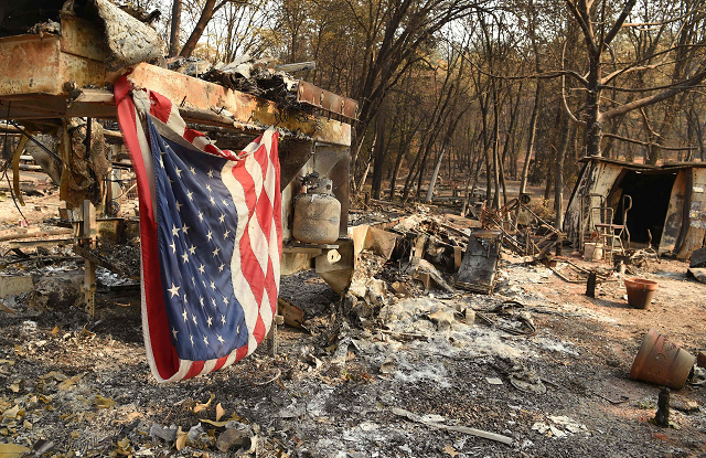 an american flag hangs at a burned out mobile home park in paradise photo afp an american flag hangs at a burned out mobile home park in paradise photo afp
