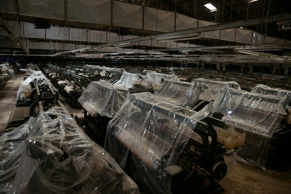 textile weaving machines are covered at a closed down textile factory in kaduna nigeria photo reuters