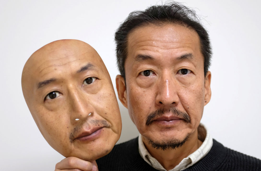 real f co president osamu kitagawa shows off a super realistic face mask at his factory in otsu western japan photo reuters