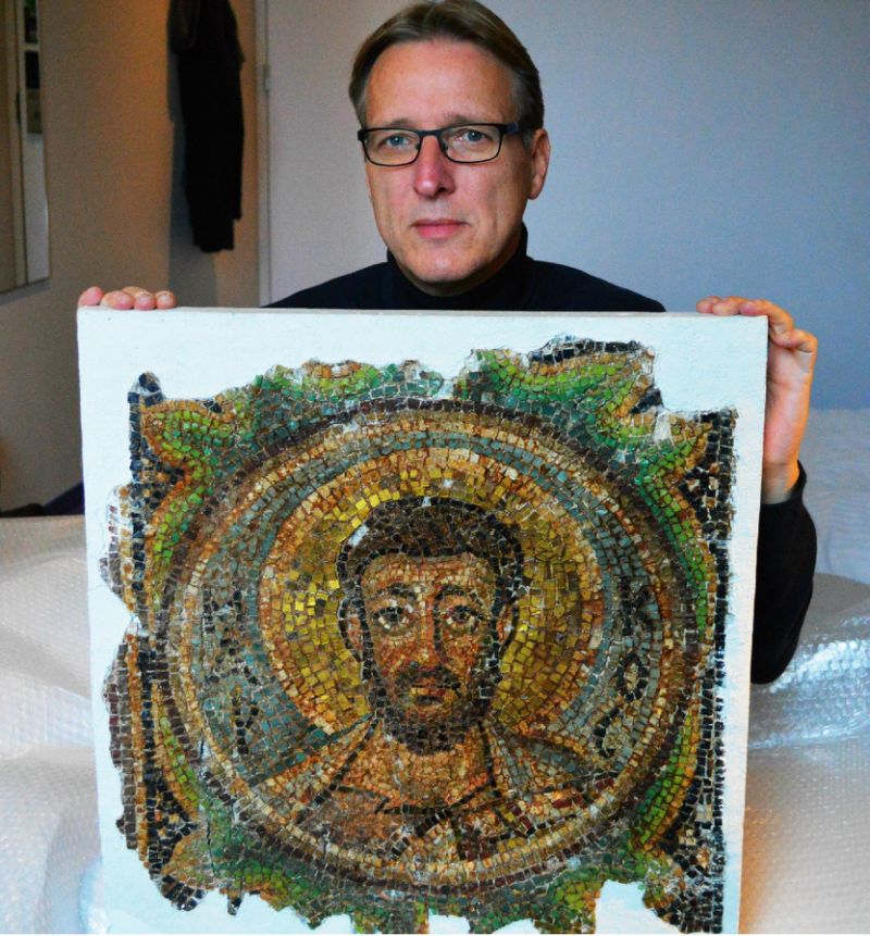 dutch art detective arthur brand poses with the missing mosaic of st mark in the hague on november 17 2018 before handing it back to cypriot authorities photo afp