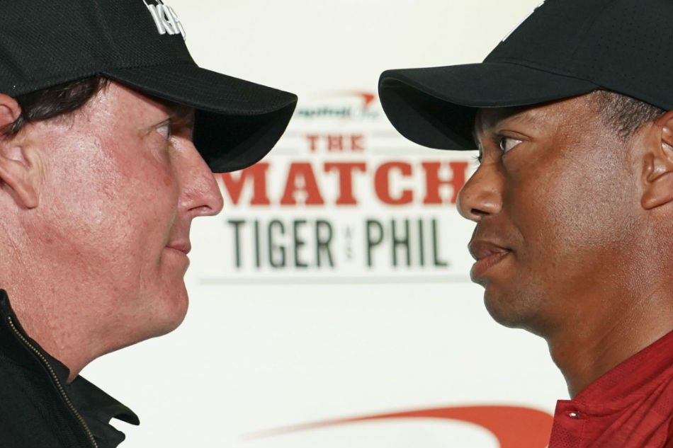 phil mickelson left and tiger woods right pose for a photo during a press conference before the match tiger vs phil golf match at shadow creek golf course photo reuters