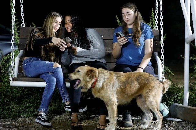 israeli teens meshy elmkies r 16 liam yefet c 16 and lee cohen 17 co managers of instagram account otef gaza look at their mobile phones as they sit on a swing at kibbutz kerem shalom which borders the gaza strip in southern israel photo reuters israeli teens meshy elmkies r 16 liam yefet c 16 and lee cohen 17 co managers of instagram account otef gaza look at their mobile phones as they sit on a swing at kibbutz kerem shalom which borders the gaza strip in southern israel photo reuters