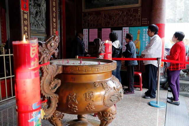 people queue to cast their votes at a polling station inside a temple during local elections and referendum on same sex marriage in kaohsiung taiwan november 24 2018 photo reuters people queue to cast their votes at a polling station inside a temple during local elections and referendum on same sex marriage in kaohsiung taiwan november 24 2018 photo reuters