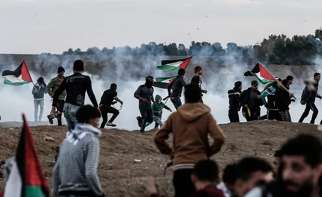 palestinians react to tear gas fired by israeli forces during a protest in the eastern outskirts of gaza city near the border with israel photo afp palestinians react to tear gas fired by israeli forces during a protest in the eastern outskirts of gaza city near the border with israel photo afp