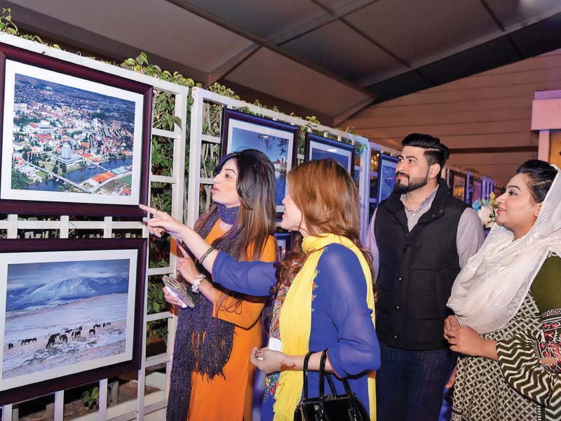 visitors look at pictures displayed on the occasion of the national day of bosnia in the capital photo dna