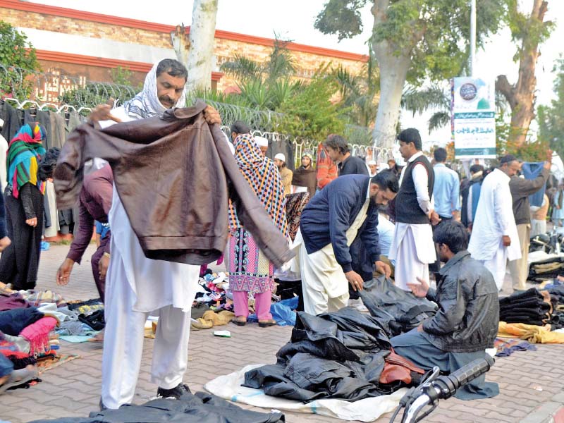 people buy winter clothing in islamabad as the weather turns cold photo express