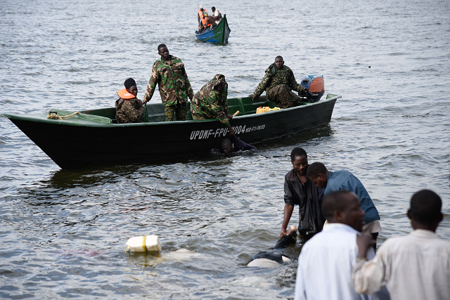 ugandan navy personnel and local fishermen collect bodies of victims by capsized cruise boat on lake victoria photo afp ugandan navy personnel and local fishermen collect bodies of victims by capsized cruise boat on lake victoria photo afp