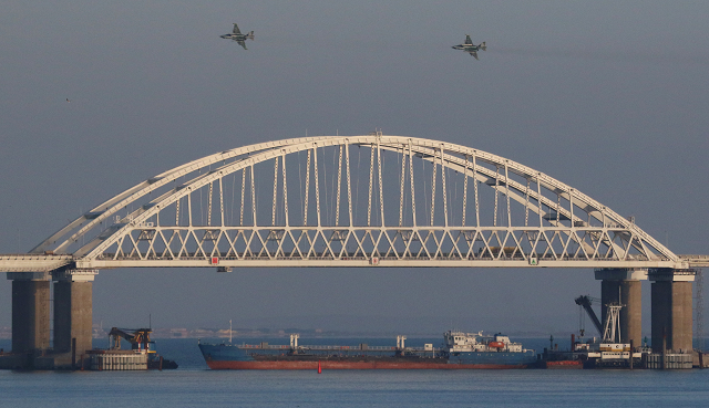russian jet fighters fly over a bridge connecting the russian mainland with the crimean peninsula with a cargo ship beneath it after three ukrainian navy vessels were stopped by russia from entering the sea of azov via the kerch strait in the black sea crimea november 25 2018 photo reuters russian jet fighters fly over a bridge connecting the russian mainland with the crimean peninsula with a cargo ship beneath it after three ukrainian navy vessels were stopped by russia from entering the sea of azov via the kerch strait in the black sea crimea november 25 2018 photo reuters