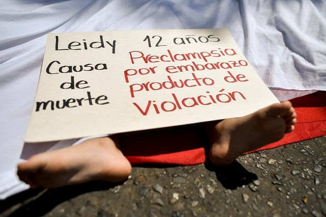 a girl takes part in a performance during a march on the international day for the elimination of violence against women in cali valle del cauca department colombia on november 25 2018 photo afp a girl takes part in a performance during a march on the international day for the elimination of violence against women in cali valle del cauca department colombia on november 25 2018 photo afp