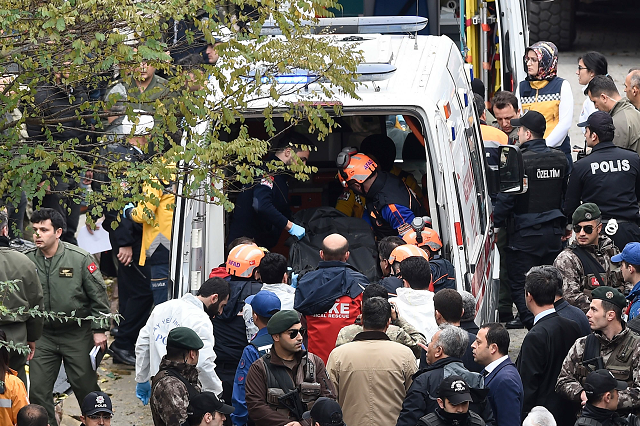 this handout picture released by demiroren news agency shows rescue workers and emergency services members carrying a coffin of a soldier who died after a helicopter crash in istanbul on november 26 2018 photo afp