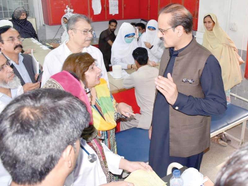 federal health minister aamer mehmood kiani listens to the problems of doctors during is visit to the polyclinic on saturday photo waseem nazir express