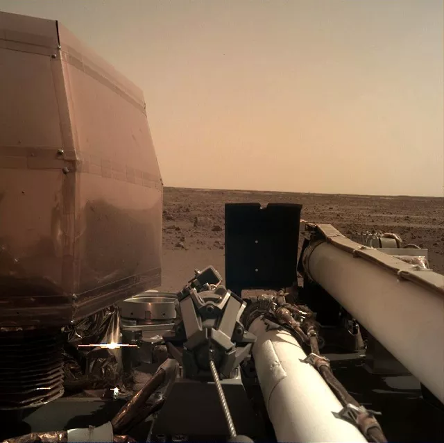 this handout image released by nasa jpl caltech on november 26 2018 and acquired by nasa 039 s insight mars lander using its robotic arm mounted instrument deployment camera idc shows a view from nasa 039 s insight lander after it touched down on the surface of mars   nasa 039 s usd 993 million mars insight lander successfully touched down on the red planet to listen for quakes and study how rocky planets formed the us space agency said photo afp