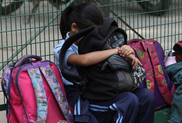 a girl rests her head against a bag outside a school in new delhi india photo reuters a girl rests her head against a bag outside a school in new delhi india photo reuters