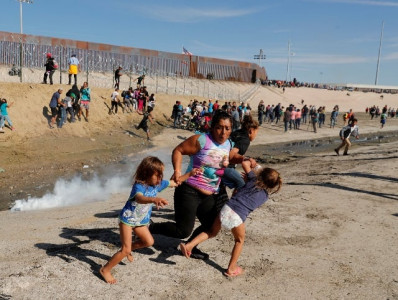 honduran migrant clutching two small children flees tear gas honduran migrant clutching two small children flees tear gas