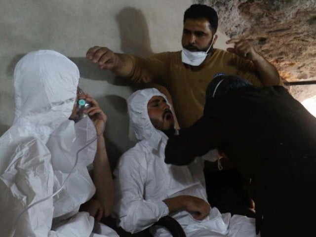 a man breathes through an oxygen mask as another one receives treatments after what rescue photo afp a man breathes through an oxygen mask as another one receives treatments after what rescue photo afp