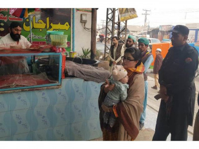 k p woman official sets example by carrying infant while on duty