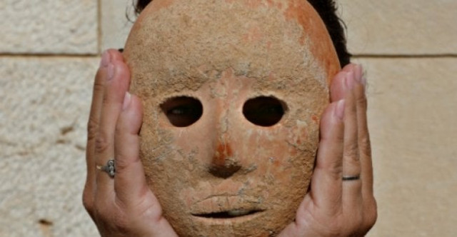 israeli archeologist ronit lupu holds a rare stone mask dating to the neolithic period which was found at the pnei hever region of southern hebron mount photo afp