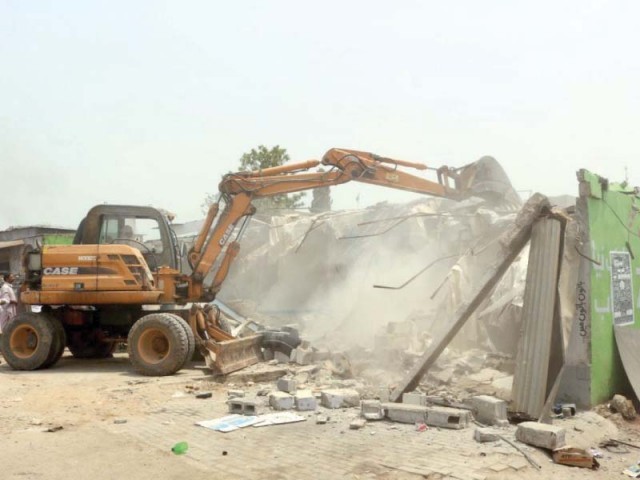 cda staff use an excavator to tear down encroachment photo express