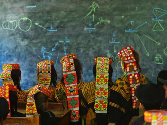 in this photograph taken on october 31 2015 kalash students attend a class at a school in the brun village of bumboret valley photo afp