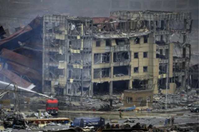 rescuers work at the site of explosions in tianjin north east china on august 14 2015 photo afp