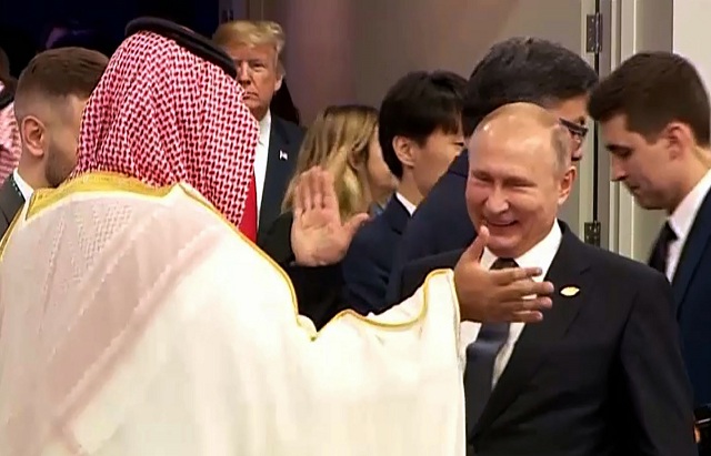 russia 039 s president vladimir putin and saudi arabia 039 s crown prince mohammed bin salman greet each other at the g20 leaders 039 summit in buenos aires on november 30 2018 as us president donald trump enter the room c left rear photo afp