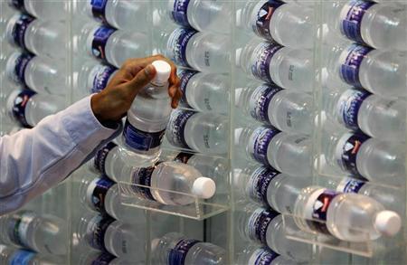 a booth attendant displays a bottle of water photo reuters