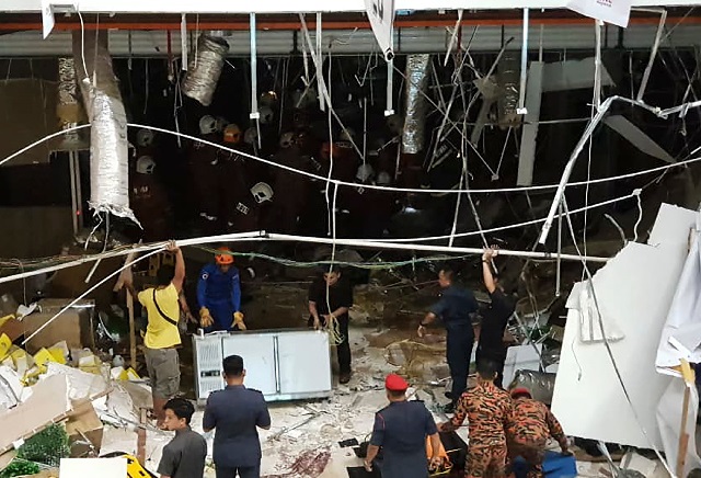 malaysian security personnel inspect the site after an explosion at the city one megamall in kuching the capital city of sarawak state on december 4 2018   three people were killed and 24 injured on december 4 when a powerful explosion rocked a shopping mall in the malaysian state of sarawak but a fire official said it was not caused by a bomb photo afp