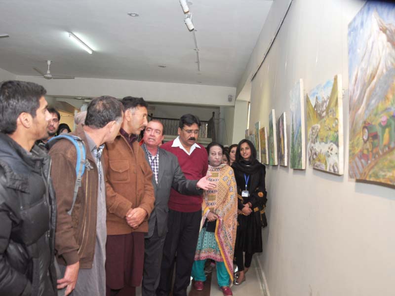 mountaineer hassan jan and devcom pakistan executive director munir ahmed review paintings made by students for an exhibition as part of the 8th pakistan mountain festival photo express