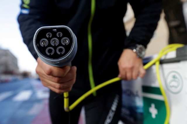 a courier holds an electric car charging cable of a mobile charging station on a street in prague czech republic december 4 2018 photo reuters